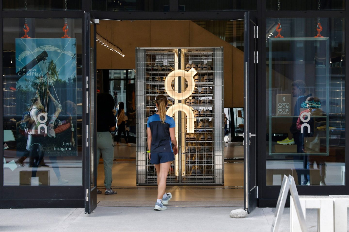 A runner enters the On Labs flagship store, operated by On Holdings AG, in Zurich, Switzerland, on Tuesday, March 21, 2023. Swiss sneaker maker On predicted that its tennis and running footwear will drive sales growth of almost 40% this year as the upstart eats into a sports footwear market traditionally dominated by larger rivals Adidas AG and Nike Inc. Photographer: Stefan Wermuth/Bloomberg via Getty Images